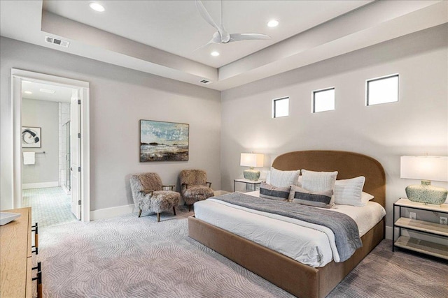 27 Wingreen Loop, The Hills, TX 78738 - bedroom featuring carpet flooring, recessed lighting, connected bathroom, and a raised ceiling