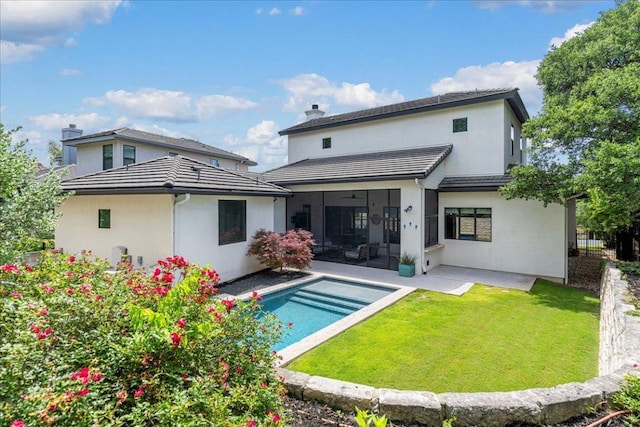 27 Wingreen Loop, The Hills, TX 78738 - back of house featuring a lawn, an outdoor pool, stucco siding, and a sunroom