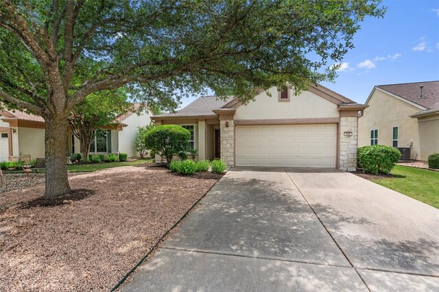 233 Crockett Loop, Georgetown, TX 78633 - view of front of house with stone siding, a garage, concrete driveway, and stucco siding