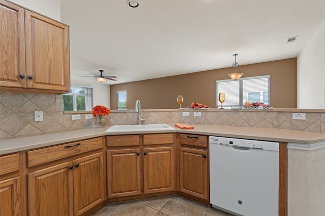 233 Crockett Loop, Georgetown, TX 78633 - kitchen with white dishwasher, a sink, tasteful backsplash, a ceiling fan, and light countertops
