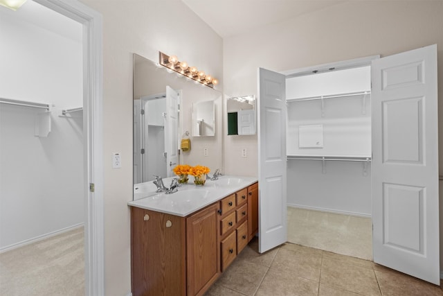 233 Crockett Loop, Georgetown, TX 78633 - full bath featuring double vanity, a walk in closet, tile patterned flooring, and baseboards