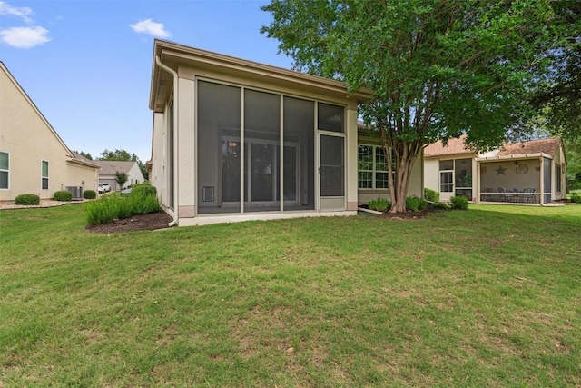 233 Crockett Loop, Georgetown, TX 78633 - rear view of house featuring a sunroom, a lawn, and central AC unit