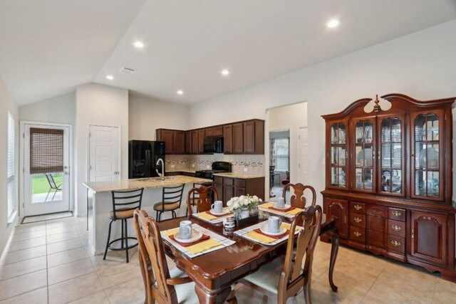 6032 Urbano Bnd, Round Rock, TX 78665 - dining area featuring light tile patterned flooring, lofted ceiling, and recessed lighting