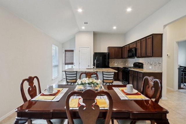 6032 Urbano Bnd, Round Rock, TX 78665 - dining room with light tile patterned flooring, vaulted ceiling, and recessed lighting