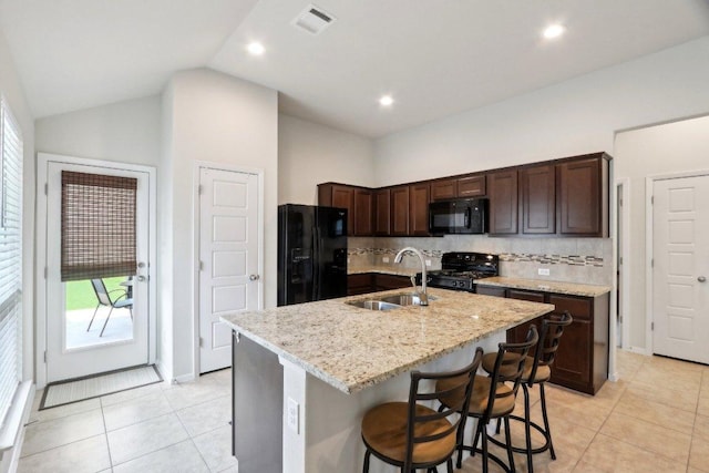6032 Urbano Bnd, Round Rock, TX 78665 - kitchen with black appliances, light tile patterned floors, dark brown cabinets, backsplash, and recessed lighting