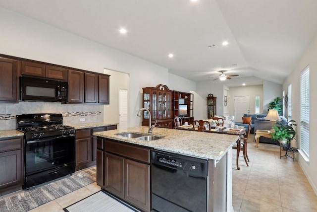 6032 Urbano Bnd, Round Rock, TX 78665 - kitchen with black appliances, light tile patterned floors, decorative backsplash, ceiling fan, and lofted ceiling