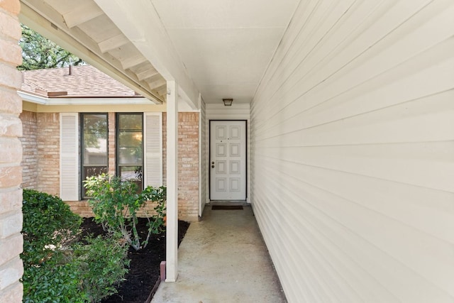 entrance to property featuring brick siding