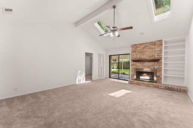 unfurnished living room featuring a skylight, high vaulted ceiling, carpet floors, beam ceiling, and a fireplace