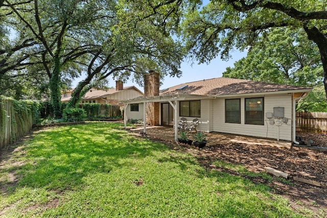 back of house with a shingled roof and a patio