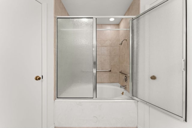 bathroom featuring shower / bath combination with glass door