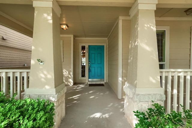 view of exterior entry with a porch