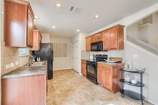 kitchen featuring black appliances, a sink, backsplash, recessed lighting, and brown cabinetry