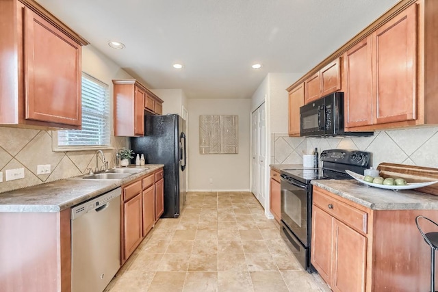 kitchen with black appliances, a sink, decorative backsplash, recessed lighting, and baseboards
