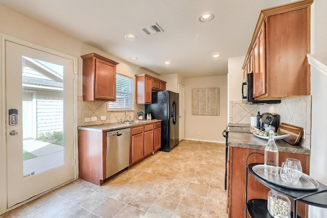 kitchen featuring black appliances, brown cabinets, backsplash, and recessed lighting