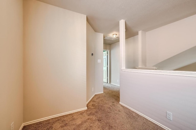 spare room featuring carpet floors and baseboards