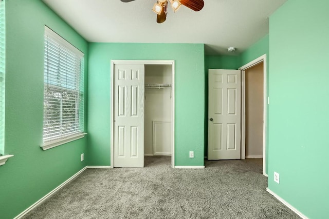 unfurnished bedroom with carpet flooring, a closet, baseboards, and ceiling fan