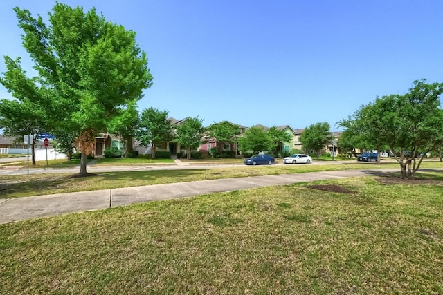 view of green lawn featuring a residential view