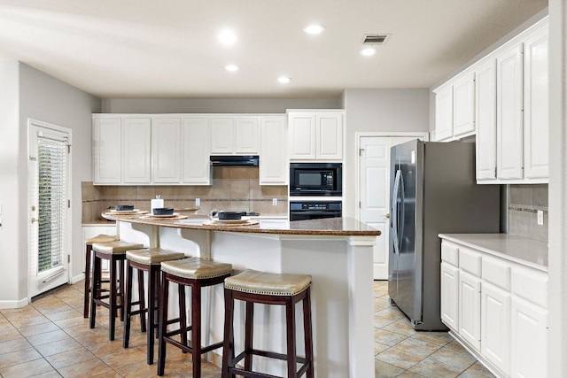 3805 Durnberry Ln, Round Rock, TX 78664 - kitchen featuring black appliances, tasteful backsplash, under cabinet range hood, white cabinetry, and recessed lighting