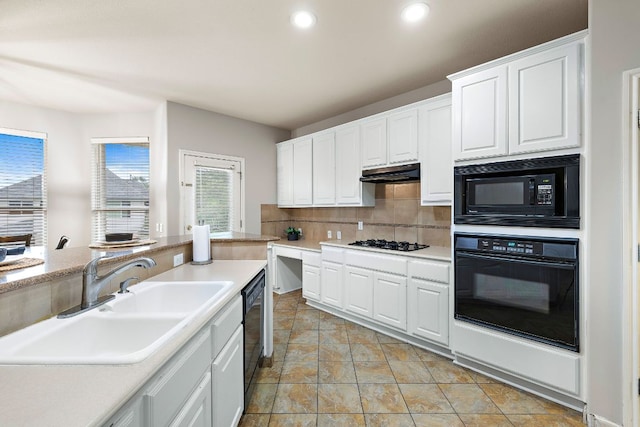 3805 Durnberry Ln, Round Rock, TX 78664 - kitchen featuring black appliances, tasteful backsplash, white cabinets, light countertops, and under cabinet range hood