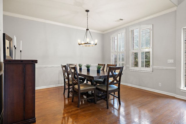 3805 Durnberry Ln, Round Rock, TX 78664 - dining room featuring a chandelier, wood finished floors, and crown molding