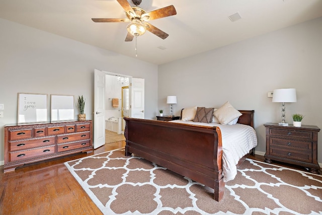 3805 Durnberry Ln, Round Rock, TX 78664 - bedroom featuring wood finished floors, connected bathroom, and ceiling fan