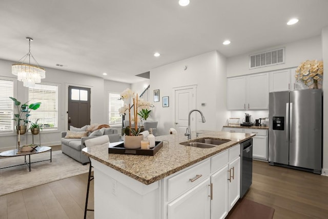 2520 Bluebonnet Ln Unit 32, Austin, TX 78704 - kitchen featuring stainless steel refrigerator with ice dispenser, a sink, dishwashing machine, dark wood-style floors, and white cabinetry