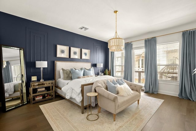 2520 Bluebonnet Ln Unit 32, Austin, TX 78704 - bedroom with multiple windows, a chandelier, dark wood-style flooring, and baseboards