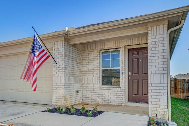 12224 Token Trl, Elgin, TX 78621 - doorway to property with fence, brick siding, and a garage