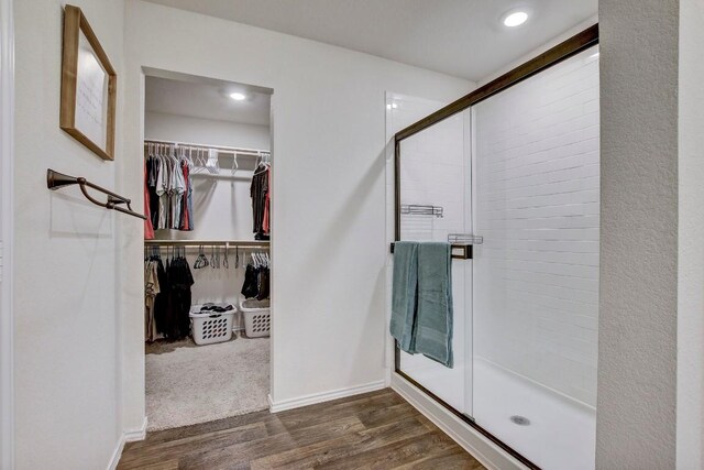 12224 Token Trl, Elgin, TX 78621 - full bath with a stall shower, wood finished floors, a spacious closet, baseboards, and recessed lighting