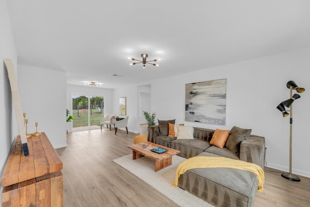 8104 Valleyfield Dr, Austin, TX 78724 - living area featuring a chandelier, light wood-style flooring, and baseboards