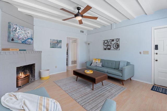4611 Rosedale Ave, Austin, TX 78756 - living room featuring beamed ceiling, ceiling fan, wood finished floors, a fireplace, and baseboards