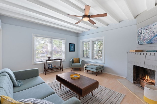 4611 Rosedale Ave, Austin, TX 78756 - living area with beamed ceiling, a ceiling fan, light wood-style flooring, a fireplace with flush hearth, and baseboards