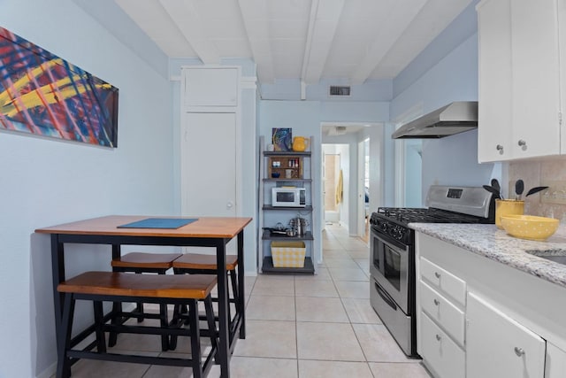 4611 Rosedale Ave, Austin, TX 78756 - kitchen featuring gas stove, ventilation hood, white microwave, white cabinets, and beam ceiling