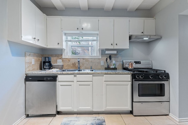 4611 Rosedale Ave, Austin, TX 78756 - kitchen featuring appliances with stainless steel finishes, under cabinet range hood, a sink, and light tile patterned floors
