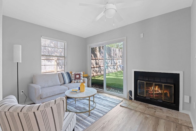 4611 Rosedale Ave, Austin, TX 78756 - living room featuring wood finished floors, a glass covered fireplace, and a ceiling fan