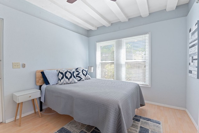4611 Rosedale Ave, Austin, TX 78756 - bedroom featuring beamed ceiling, wood finished floors, and baseboards