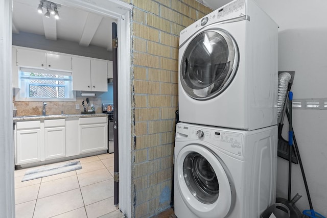 4611 Rosedale Ave, Austin, TX 78756 - laundry area featuring stacked washer / drying machine and light tile patterned floors