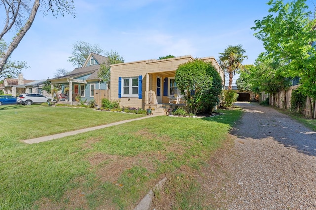 4611 Rosedale Ave, Austin, TX 78756 - view of front of house with covered porch, a front lawn, and gravel driveway