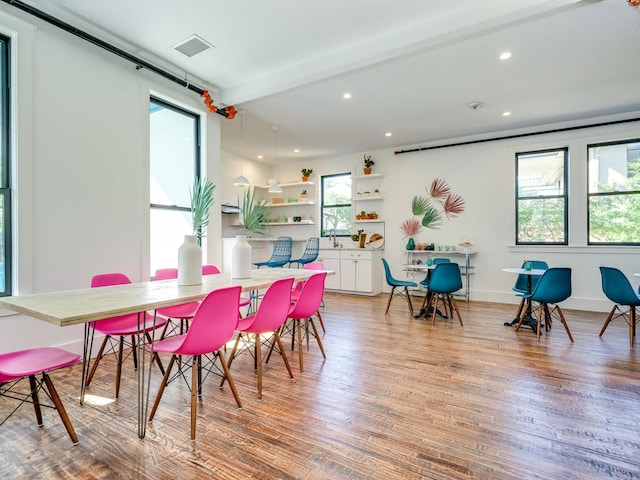 dining room featuring healthy amount of natural light, light wood-style floors, and recessed lighting
