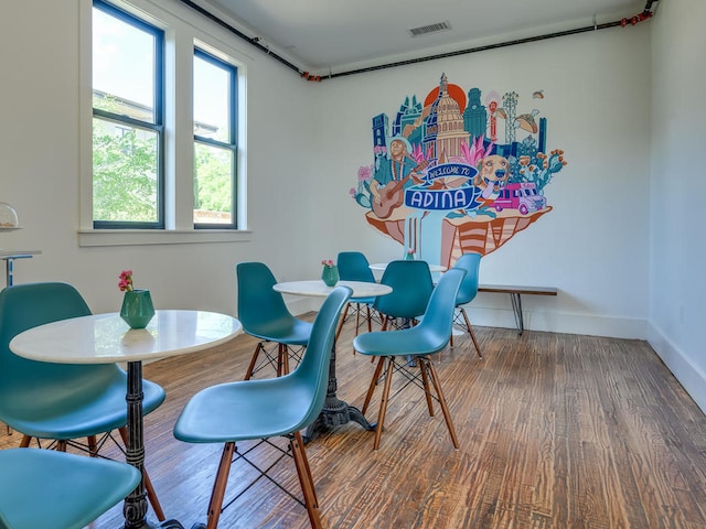 dining room featuring wood finished floors and baseboards