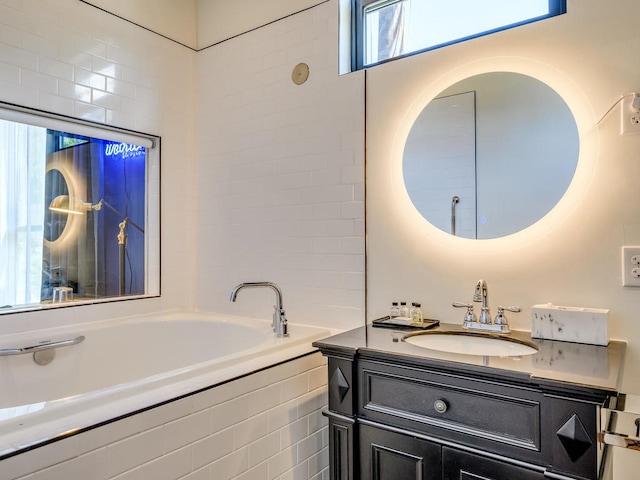 full bathroom with a garden tub and vanity