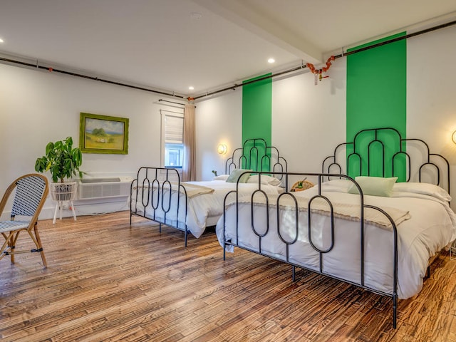 bedroom with recessed lighting and wood finished floors