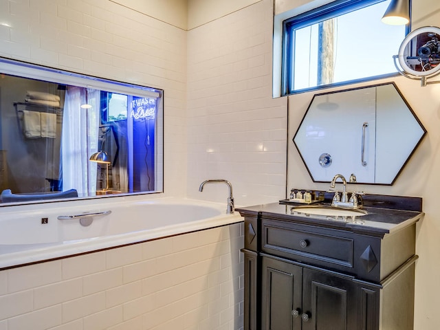 full bath with a garden tub and vanity