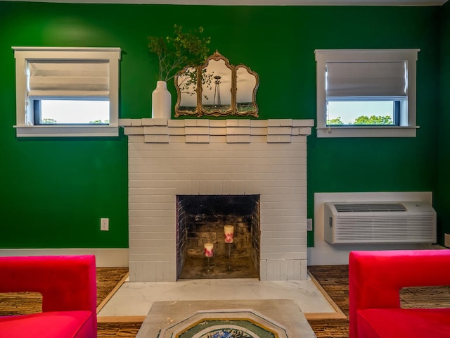 living room featuring healthy amount of natural light, a wall mounted AC, and a fireplace
