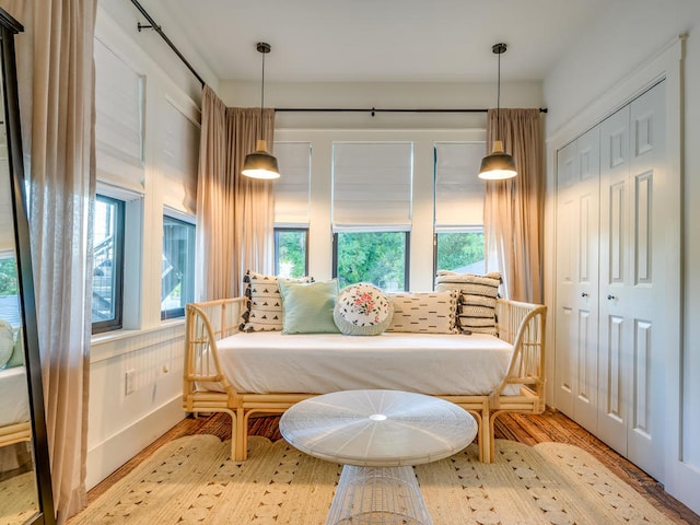 sitting room featuring plenty of natural light, wood finished floors, and baseboards