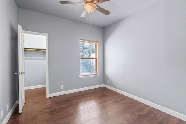 2414 Longview St Unit 303, Austin, TX 78705 - unfurnished bedroom featuring a walk in closet, dark wood finished floors, a closet, and ceiling fan