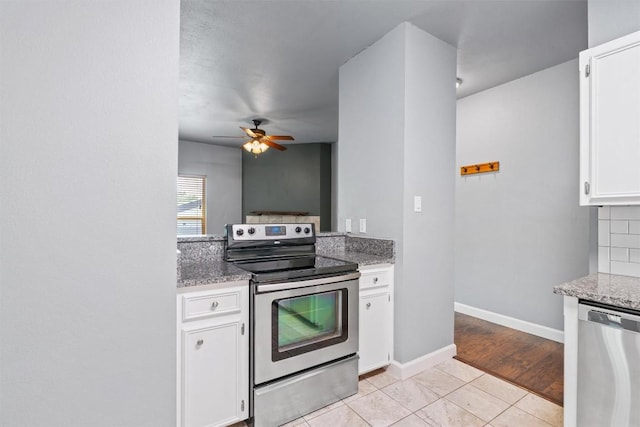 2414 Longview St Unit 303, Austin, TX 78705 - kitchen with stainless steel appliances, white cabinetry, light stone countertops, ceiling fan, and backsplash