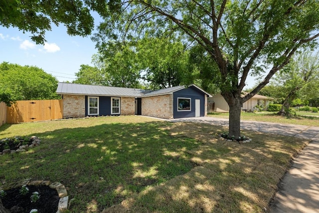 7002 Teaberry Dr, Austin, TX 78745 - view of front of property featuring a metal roof, brick siding, and a gate