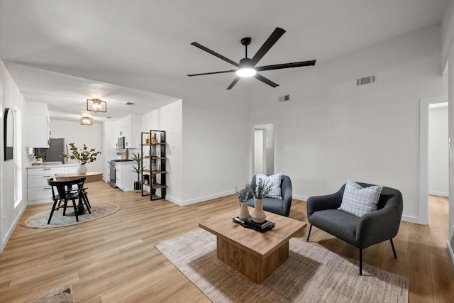 7002 Teaberry Dr, Austin, TX 78745 - living area featuring ceiling fan, light wood-style flooring, and a towering ceiling