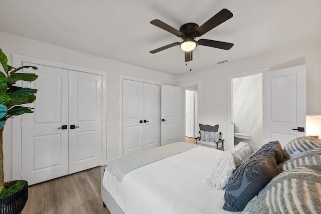 7002 Teaberry Dr, Austin, TX 78745 - bedroom with multiple closets, light wood finished floors, ensuite bathroom, and a ceiling fan